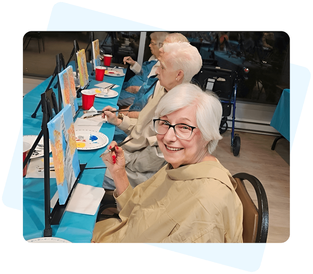 Seniors painting at an art class.