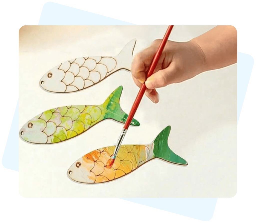 Hand painting colorful fish shapes.